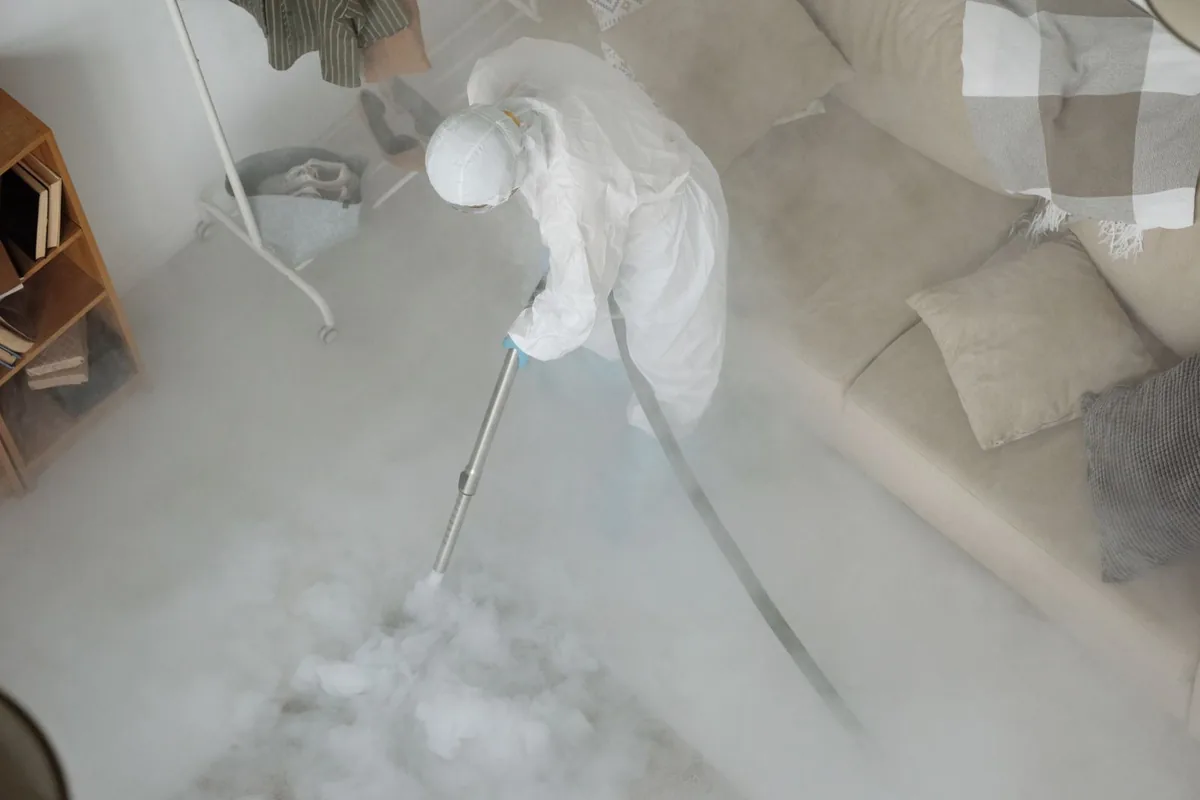 Biohazard cleanup technician in protective equipment, Lamont, MI